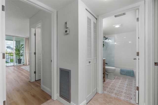 hallway with light tile patterned floors