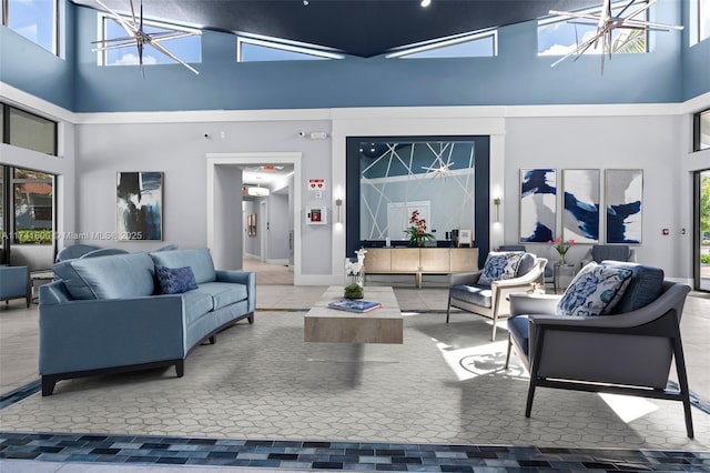 living room featuring a high ceiling and an inviting chandelier