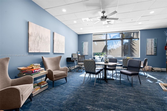 dining room with ceiling fan, carpet, and a drop ceiling