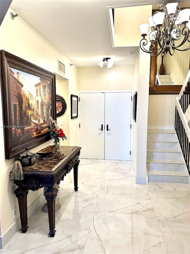 foyer with an inviting chandelier