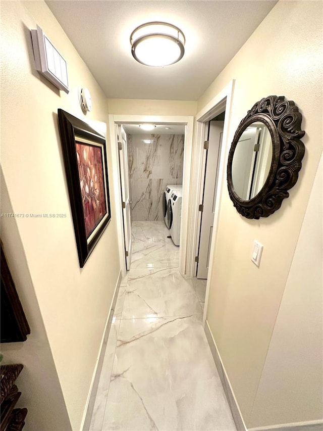 hallway featuring washer and clothes dryer