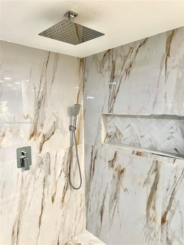 interior details featuring a tile shower