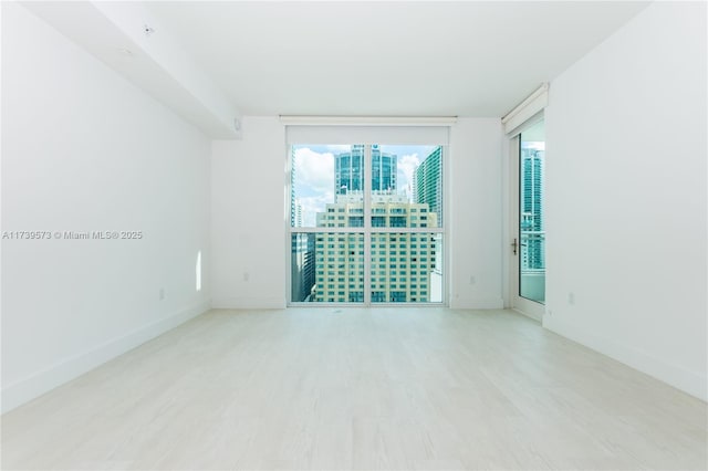 spare room featuring light hardwood / wood-style flooring