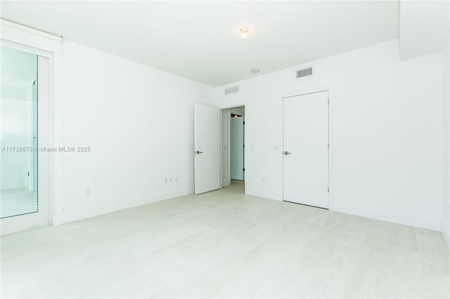 spare room with light wood-type flooring