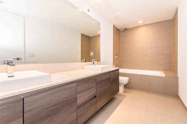 full bathroom featuring vanity, tiled shower / bath combo, and toilet