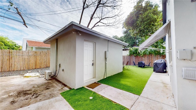 view of outdoor structure featuring a lawn