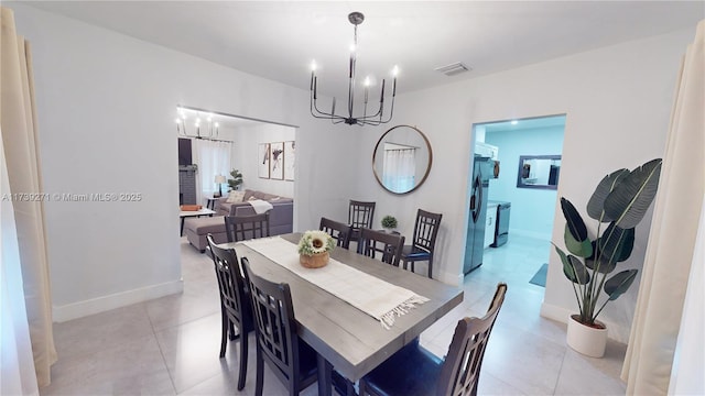 tiled dining area with a chandelier