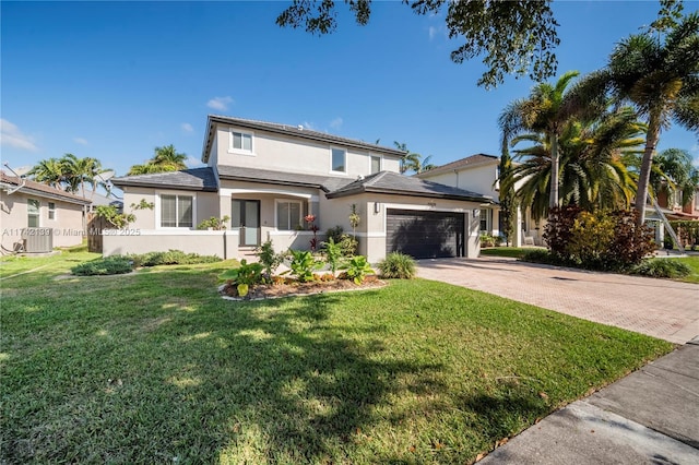 view of front of house featuring a garage, central AC, and a front yard