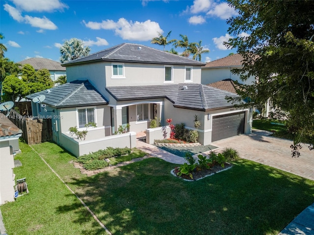 back of property featuring a garage and a yard