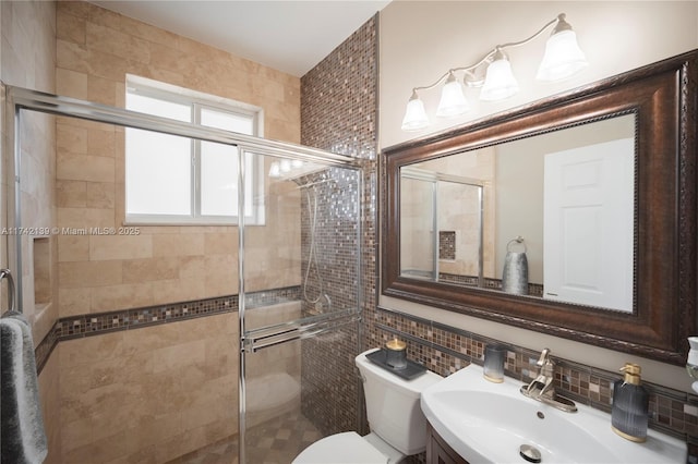 bathroom with toilet, a shower with shower door, sink, tile walls, and backsplash