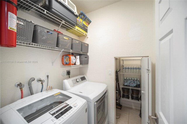 laundry room featuring tile patterned flooring and washer and dryer