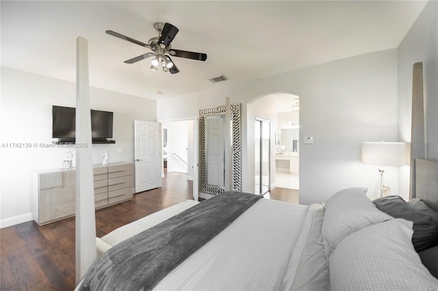 bedroom featuring ceiling fan, dark hardwood / wood-style flooring, and ensuite bath