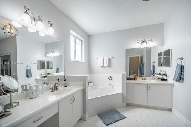 bathroom featuring vanity, tiled bath, and tile patterned flooring