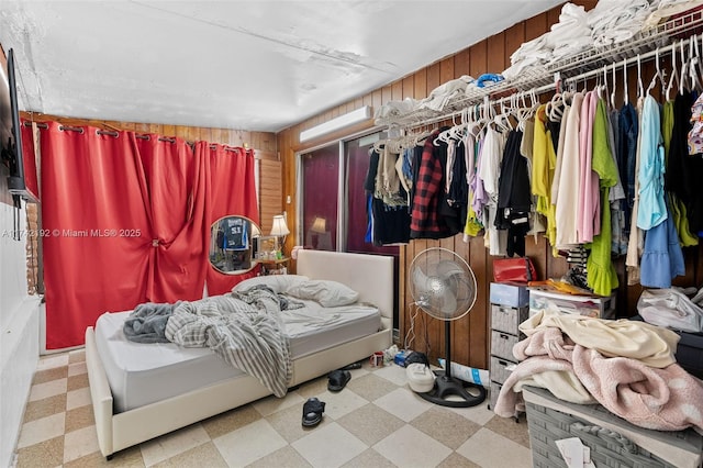 bedroom with wooden walls