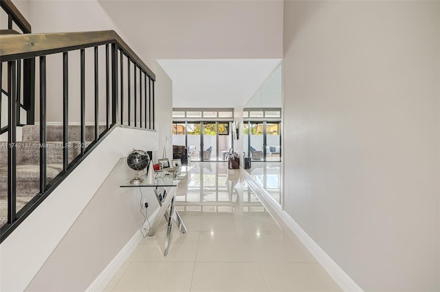 hall with tile patterned floors