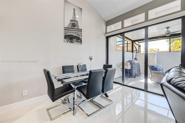 dining area featuring ceiling fan and tile patterned flooring