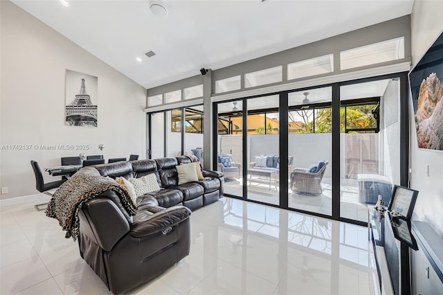 tiled living room with high vaulted ceiling