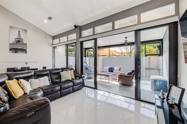 tiled living room featuring french doors, ceiling fan, and lofted ceiling