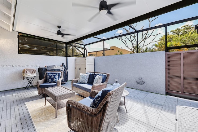 view of patio with a wooden deck, a lanai, an outdoor hangout area, and ceiling fan