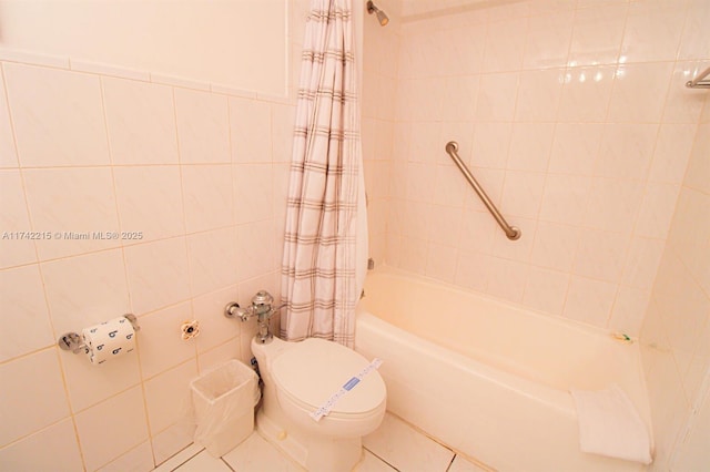 bathroom featuring shower / bath combination with curtain, toilet, and tile walls