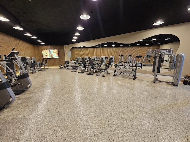 workout area featuring wood walls