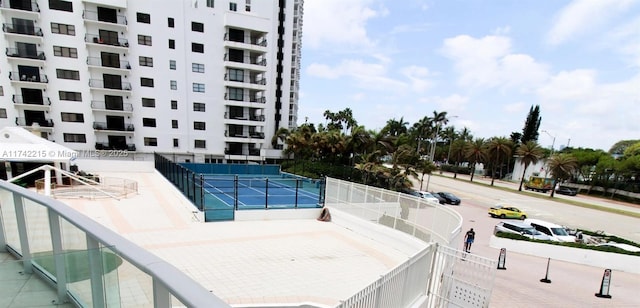 view of pool featuring tennis court