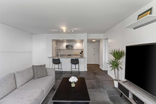 540 Brickell Key Dr Unit 1519, Miami, FL 33131 - living area with baseboards, rail lighting, and concrete flooring