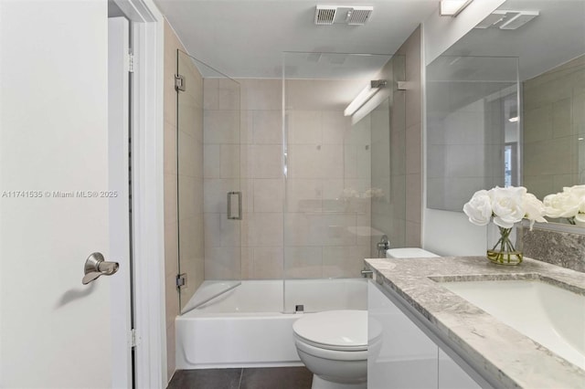 540 Brickell Key Dr Unit 1519, Miami, FL 33131 - full bathroom with visible vents, tile patterned flooring, vanity, toilet, and shower / bath combination with glass door