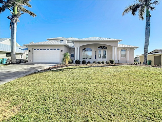 view of front of property with a garage and a front lawn