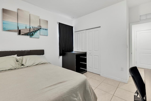 tiled bedroom with a closet