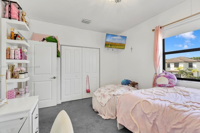 carpeted bedroom featuring a closet