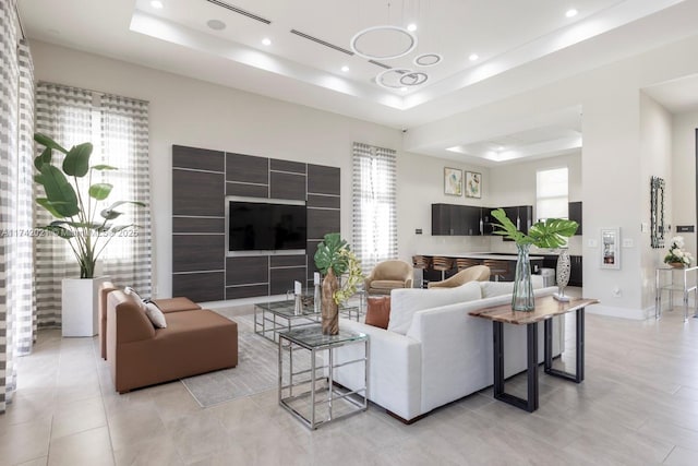 tiled living room with a raised ceiling