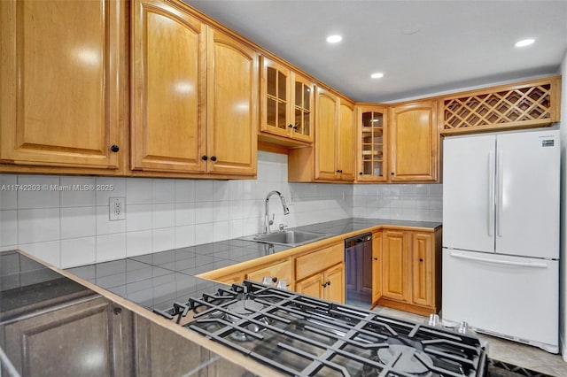 kitchen featuring sink, dishwasher, tasteful backsplash, gas stovetop, and white fridge