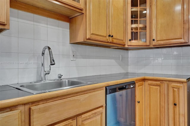 kitchen with dishwasher, tasteful backsplash, a sink, and glass insert cabinets