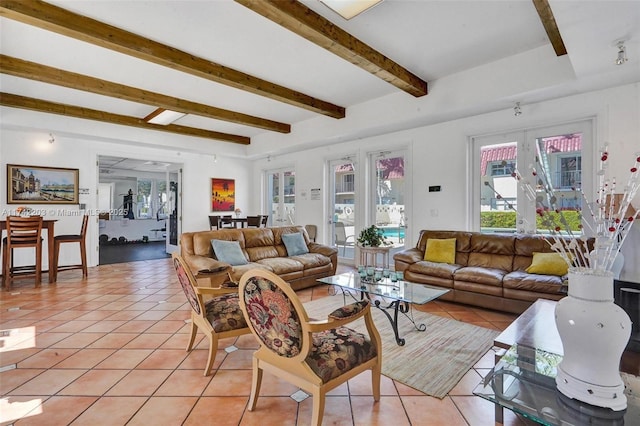 living area with french doors, beam ceiling, and light tile patterned floors