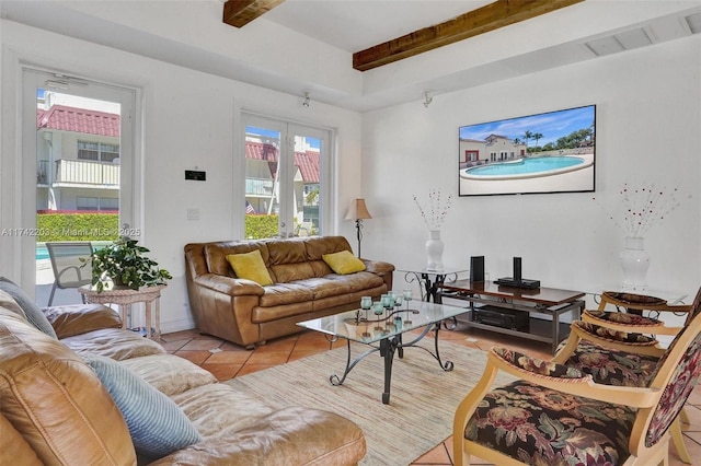 living room with beamed ceiling, visible vents, and tile patterned flooring