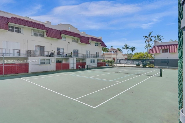 view of sport court featuring fence