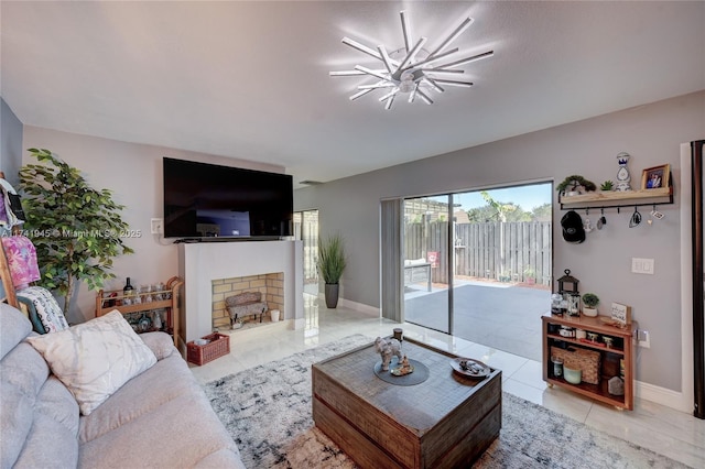 living room featuring light tile patterned floors, a brick fireplace, and a notable chandelier