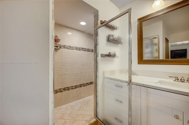 bathroom with vanity and a shower with door