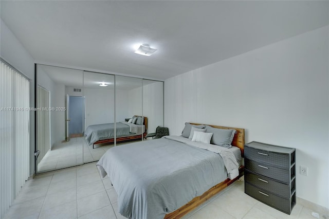 tiled bedroom with a closet