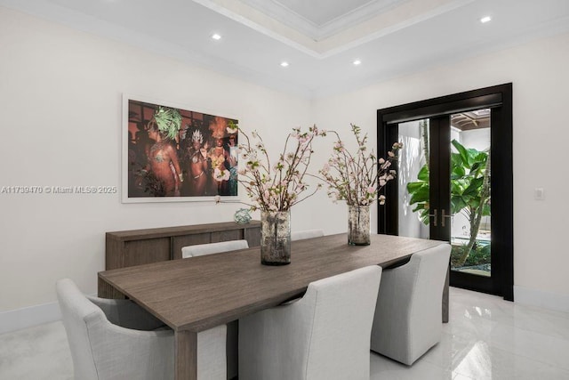 dining room featuring crown molding and a tray ceiling