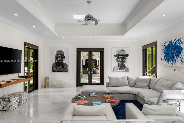 living room featuring crown molding, french doors, and a raised ceiling