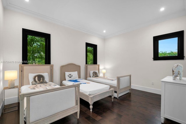 bedroom featuring ornamental molding and dark hardwood / wood-style floors