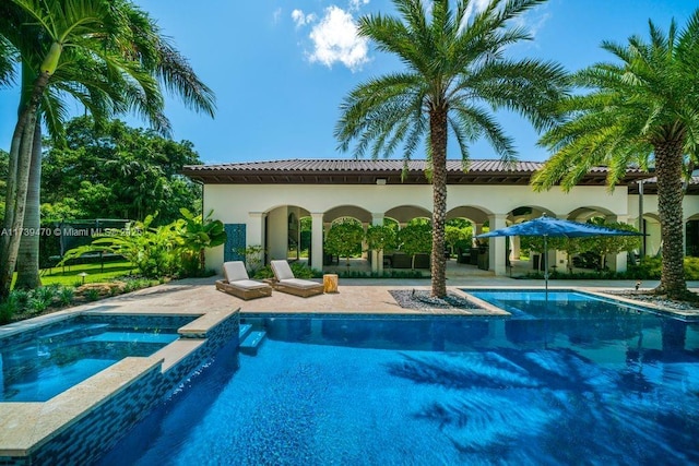 view of swimming pool with an in ground hot tub and a patio area