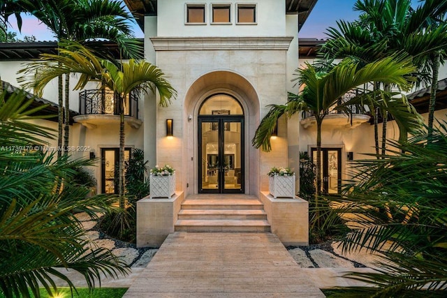 exterior entry at dusk featuring french doors