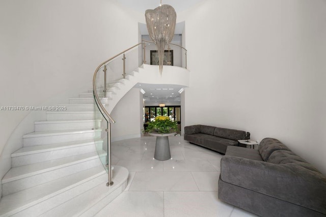 staircase with an inviting chandelier and tile patterned floors