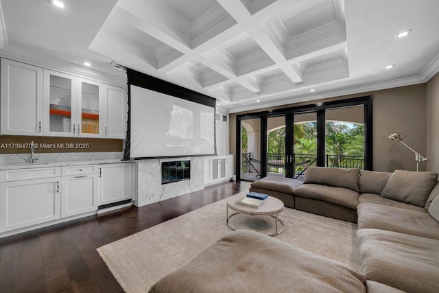 living room featuring french doors, dark wood-type flooring, coffered ceiling, crown molding, and beam ceiling