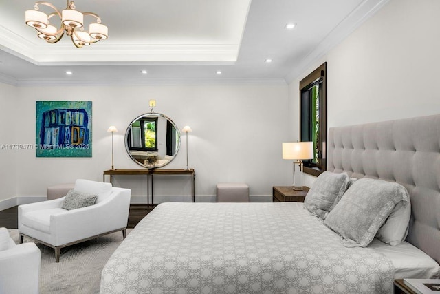 bedroom with crown molding, a tray ceiling, and a chandelier