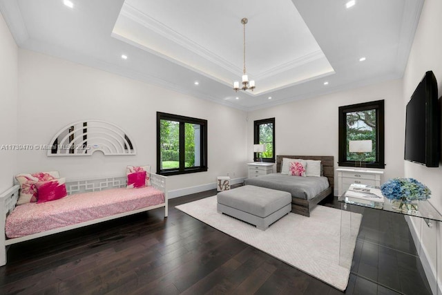 bedroom featuring dark hardwood / wood-style floors, ornamental molding, a tray ceiling, and an inviting chandelier