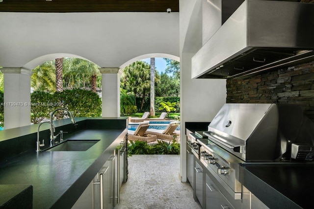 view of patio / terrace featuring an outdoor kitchen and sink